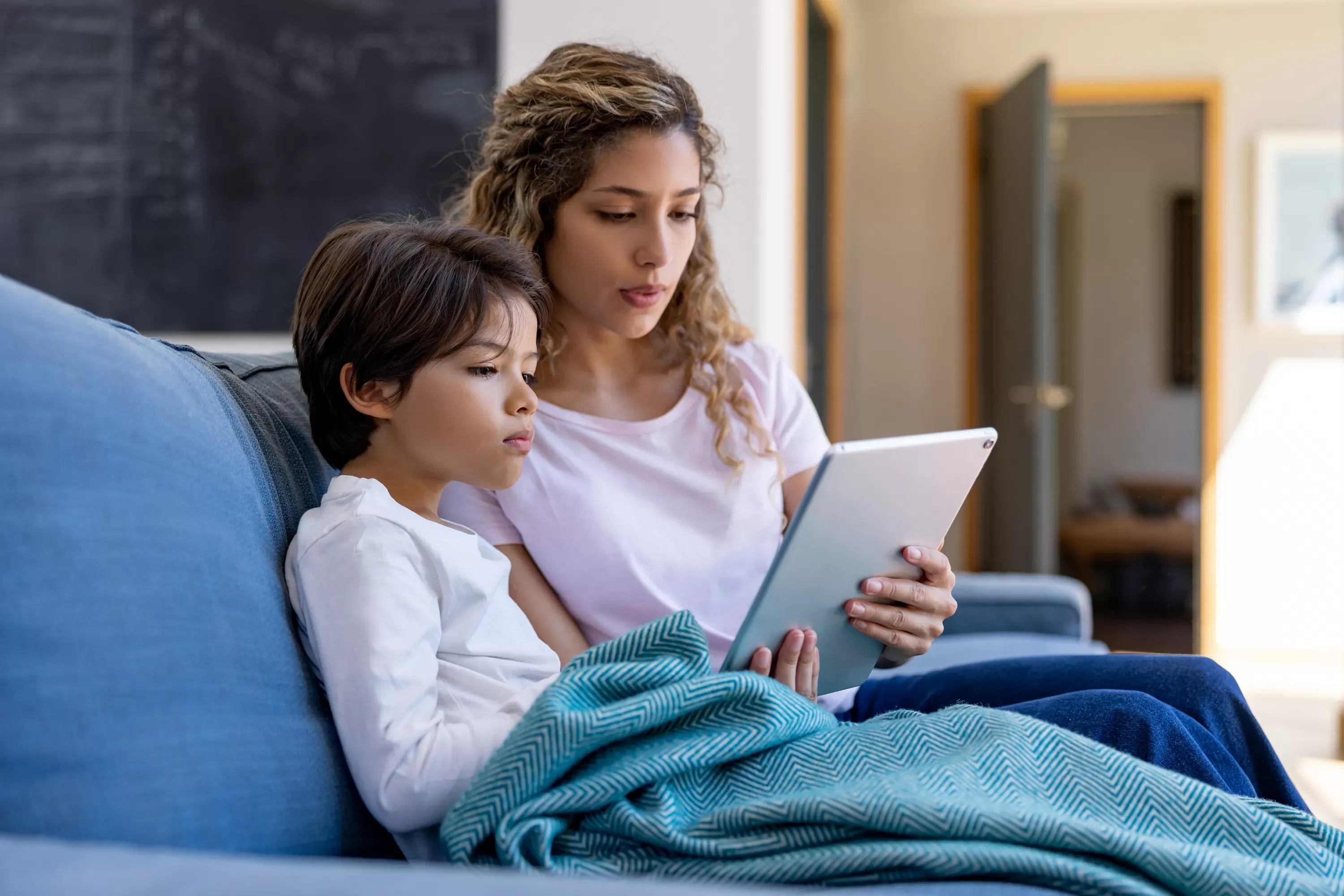 Mother looking at tablet with son Mother looking at tablet with son